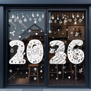 Close-up of white 2026 Christmas reindeer and snowflake static stickers on a glass door