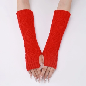 Detailed view of red knitted arm warmers with diamond cable patterns and ribbed cuffs