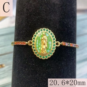 Macro detail of Guadalupe religious bracelet with green crystals and colorful zircons
