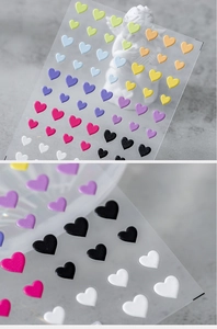 Macro detail of 5D embossed heart-shaped nail stickers with matte 3D texture in multi colors
