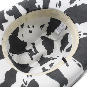 Detailed interior of cow print suede cowboy hat showing the polyester lining and labels