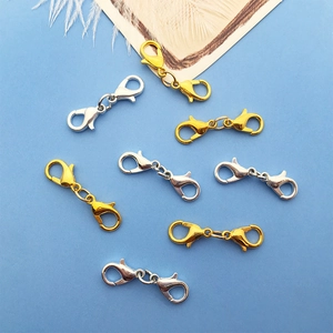 Macro view of gold and silver zinc alloy double lobster clasps for DIY jewelry making