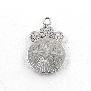 Detailed macro view of 12mm antique silver scale pendant with crown and radial texture