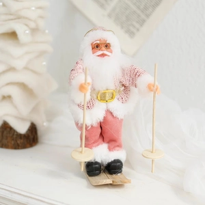 Pink and white Santa Claus figurine on wooden skis with plush details and golden glasses