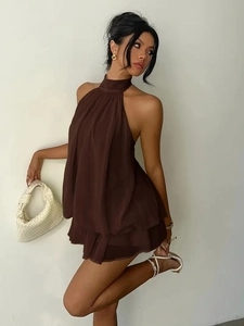 Detail of coffee brown halter chiffon dress with elegant tiered ruffle hem and pleats