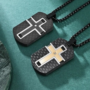 Black carbon fiber cross dog tag pendant necklaces with gold accents on green background