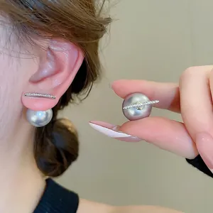 Elegant silver bar stud earrings with grey pearl drop pendant worn on a model