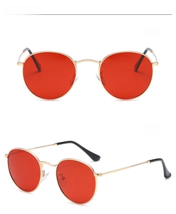 Front and side view of retro round gold metal sunglasses with vibrant red lenses