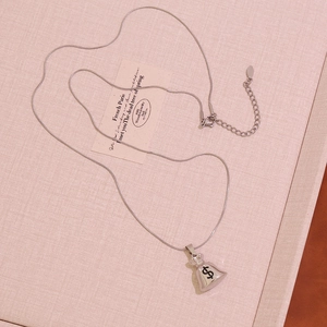 Detailed view of silver money bag pendant with dollar symbol on a sleek snake chain