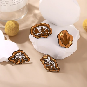 Set of four retro dinosaur fossil enamel pins featuring T-Rex and Triceratops skeletons