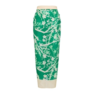 Detail view of a green floral sarong wrap with delicate plum blossom prints for beachwear