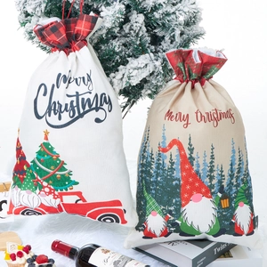 Detail of Christmas burlap drawstring gift bags with Santa print on white faux fur