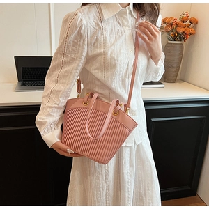 Detail showing the pink pleated texture and gold hardware of the fashion shoulder bag