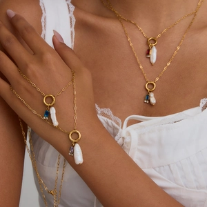 Golden multilayer body chain featuring baroque pearls and colorful gemstone pendants