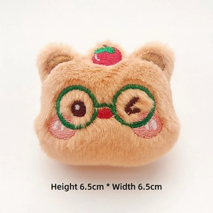 Detail of 6.5cm plush Christmas bear head with embroidery and green glasses accessory