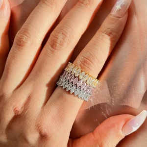 Detailed view of three marquise-cut eternity rings in gold, rose gold and silver finish