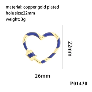 Macro detail of heart-shaped screw clasp with blue and yellow enamel and gold plating