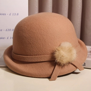Classic caramel wool beret featuring a stylish rabbit fur pompom for autumn fashion