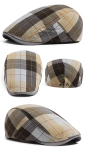 Detail view of plaid newsboy cap showing adjustable buckle and multi-color textile texture