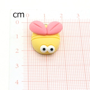 Detailed view of yellow cartoon bee charm on a ruler showing 2cm size dimensions