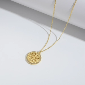 Golden St. Benedict medal pendant necklace with zircon halo on white background