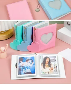 Detailed view of pastel mini photo albums with heart cutout and matching charms
