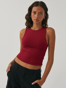 Detail of dark red ribbed knit fabric on women's slim sleeveless racerback crop top
