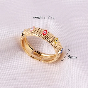 Detailed macro view of 5mm wide gold evil eye ring with colorful enamel and bead texture