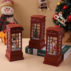 Three bronze Santa Claus telephone booth lanterns with snow globes and festive glitter