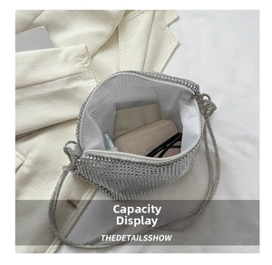 Macro shot showing internal capacity of the silver rhinestone evening bag and accessories