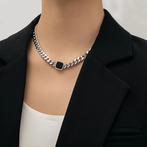 Edgy chunky titanium steel necklace featuring a black square pendant on a female model