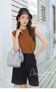 Detail of grey bucket bag with printed blue silk scarf handle on a female model