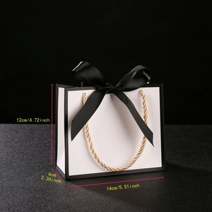 Detailed gift bag dimensions 14x12x6cm with black ribbon bow and gold rope handles