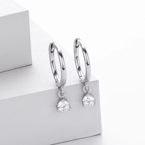 Detail of 925 sterling silver hoop earrings with clear round brilliant cut gemstones