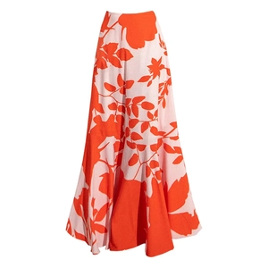 Detailed close-up of high-waist floral maxi skirt with orange leaves and pink background