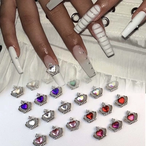 Detailed macro view of heart-shaped nail gems crown alloy charms with sparkly rhinestones