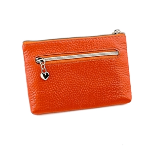 Macro view of orange genuine leather coin purse with lychee texture and heart zipper