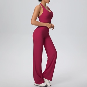 Detail of high-waist wide-leg yoga pants and halter neck sports bra in deep rose red