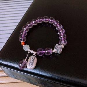 Close-up of S925 silver amethyst bracelet with ruyi knot charm on black background