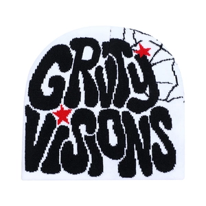 White knitted beanie with black artistic lettering and red star patterns on white background