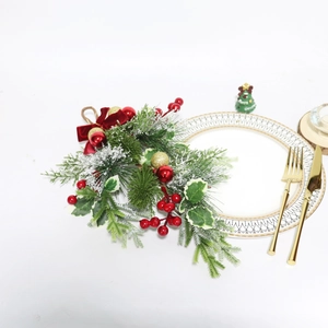 Detailed view of Christmas teardrop swag with red berries, pine needles and velvet bow