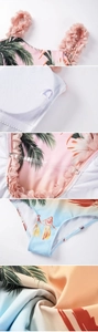 Detail of tropical palm print swimsuit with 3D floral strap and removable pads