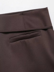 Detailed view of waist seams and faux pocket on deep brown fashion culottes