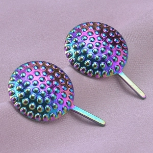 Detailed macro of 304 stainless steel stud earrings with rainbow finish and dot texture