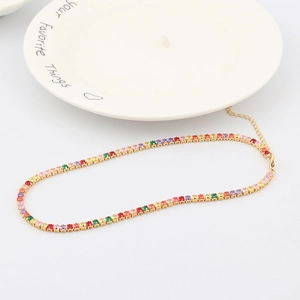 Elegant gold rainbow tennis bracelet with colorful square zircon stones on white ceramic