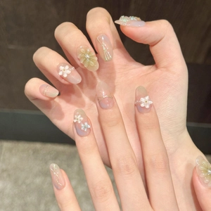 Detail of 3D floral embossed press-on nails with pearls and soft gradient finish
