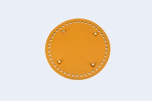 Macro detail of 15cm yellow leather bag base with golden rivets and pre-punched holes