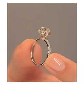 Detailed macro shot of a sparkling round faux diamond ring with floral halo design