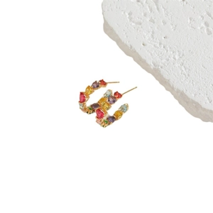 Colorful heart-shaped zircon gold C-shaped stud earrings on minimalist white stone background