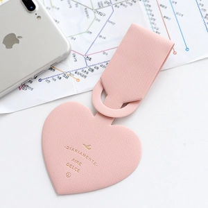 Pink heart-shaped faux leather luggage tag with gold text and fine texture detail